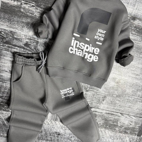 Grey sweatshirt laid flat showing the back print above matching joggers