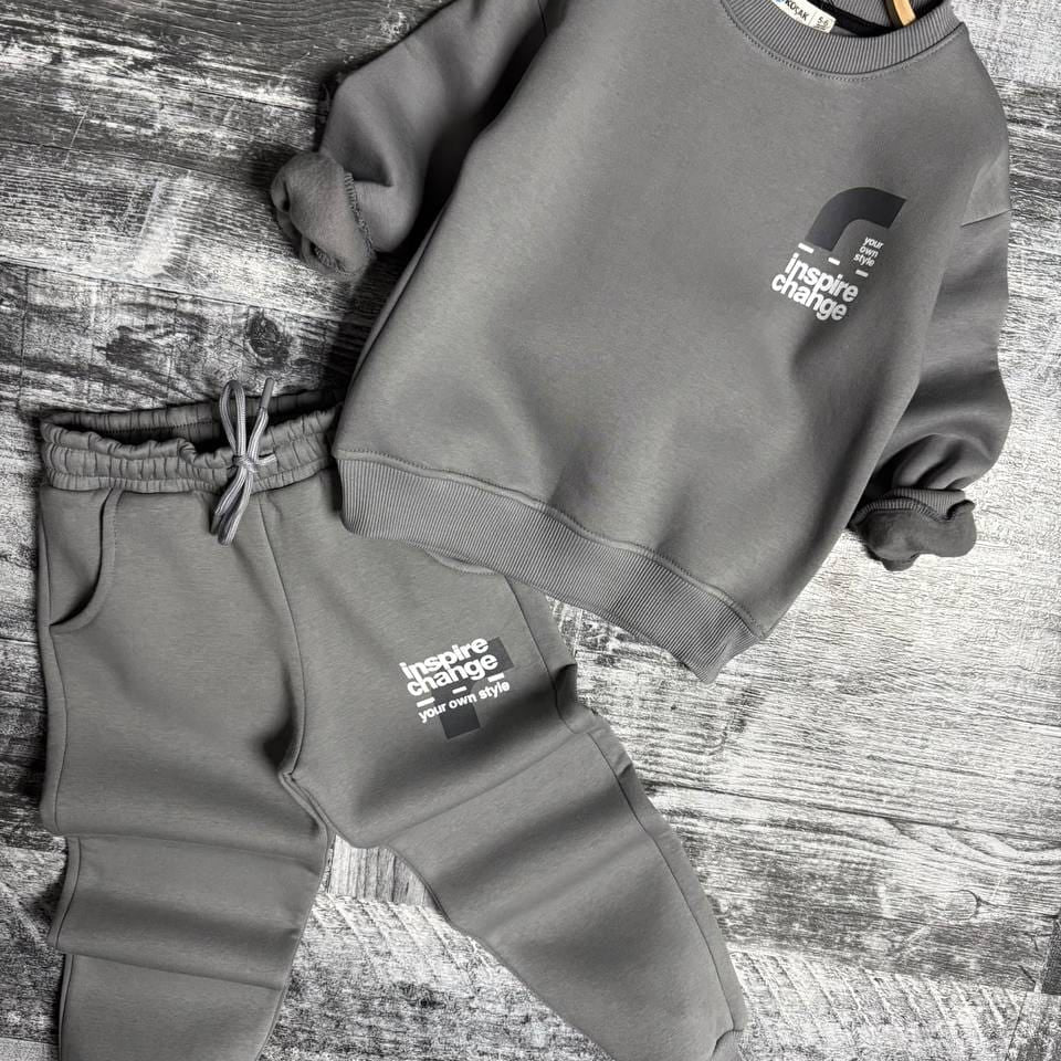 Grey sweatshirt and joggers set laid flat with small front graphic