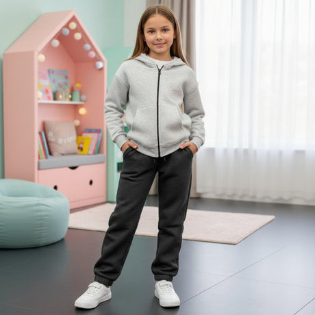 Girl in a grey zip up hoodie and matching cuffed joggers