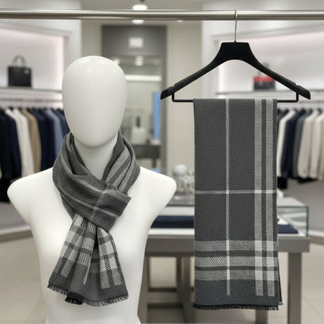 Grey plaid scarf on a mannequin and hanger in a store setting