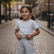 Grey two piece tee and shorts set worn on a cobbled street
