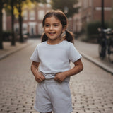 Grey two piece tee and shorts set worn on a cobbled street