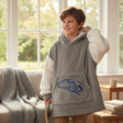 Boy wearing a grey hooded blanket with white sherpa sleeves and a blue car print