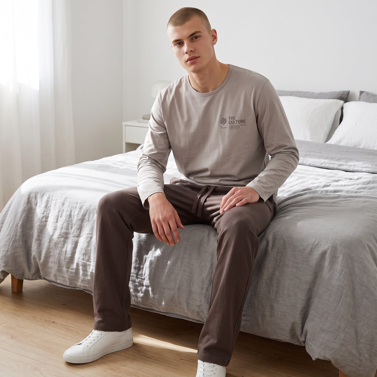 Men's stone grey pyjama top with a printed chest graphic and dark brown bottoms