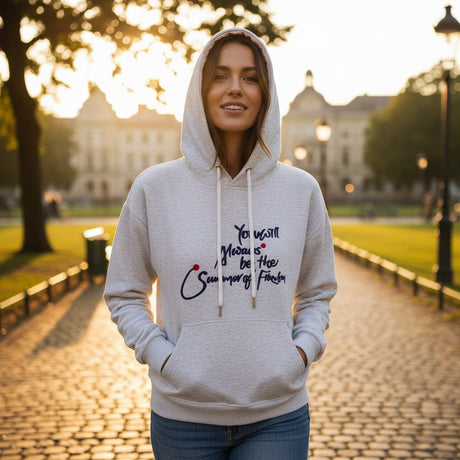 Close view of navy script lettering and red dots on grey marl fleece
