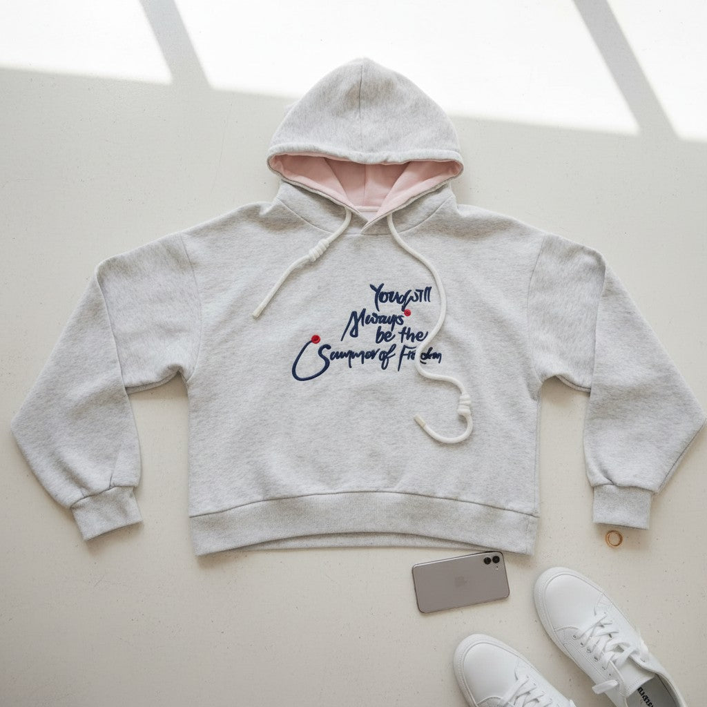 Blush pink hood lining and kangaroo pocket shown on the grey hoodie