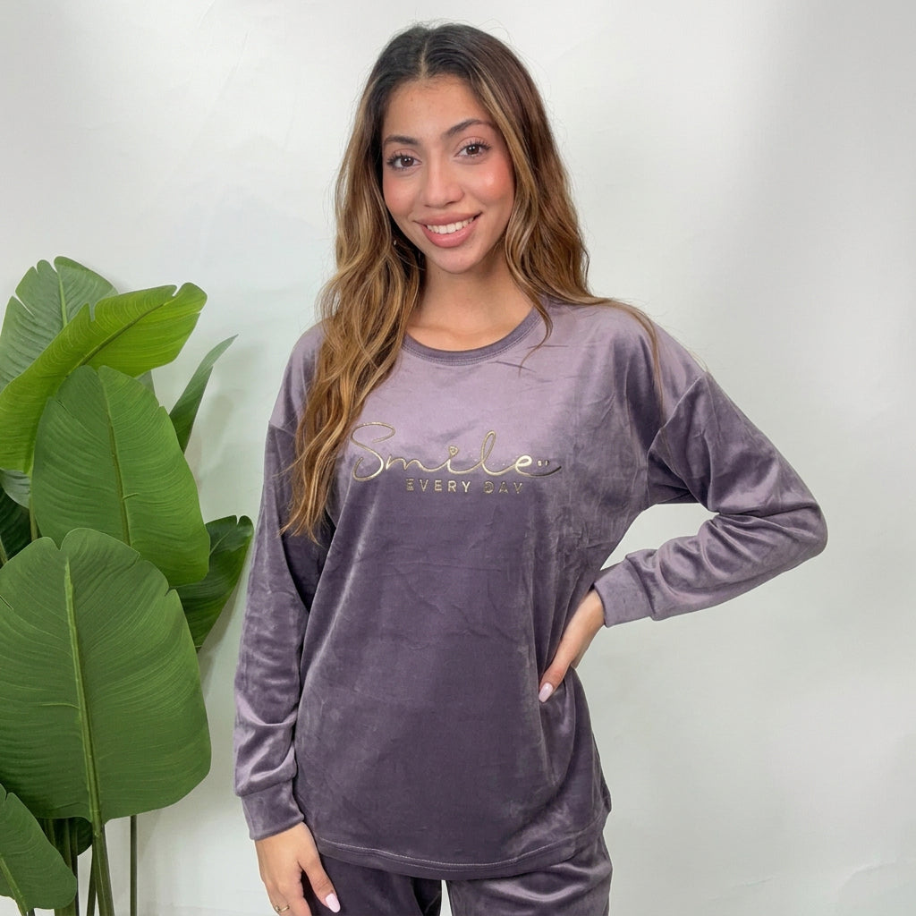 Close up of a grey velvet pajama top with metallic Smile Every Day lettering