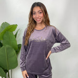 Close up of a grey velvet pajama top with metallic Smile Every Day lettering