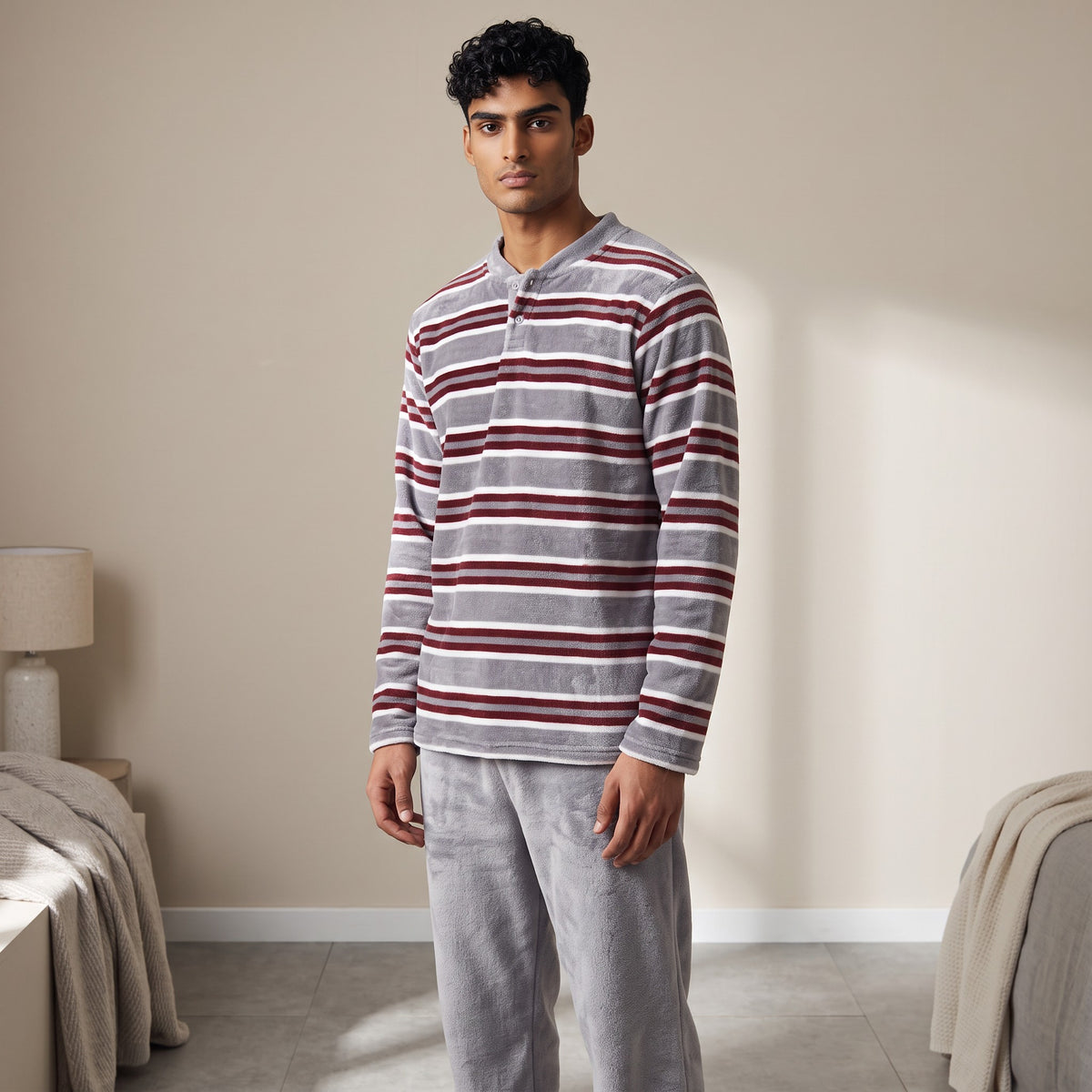 Grey fleece pyjama top with burgundy and white stripes, worn with plain grey bottoms