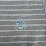 Close up of the blue outlined chest motif with OMG lettering on grey stripe pyjama fabric