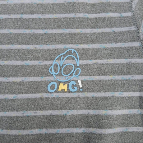 Close up of the blue outlined chest motif with OMG lettering on grey stripe pyjama fabric