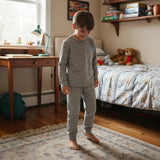 Grey striped long sleeve pajama set with a small blue chest logo and cuffed pants