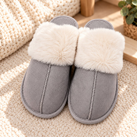 Grey suede look slippers with a fluffy cream fur collar and stitched seam on a knit rug