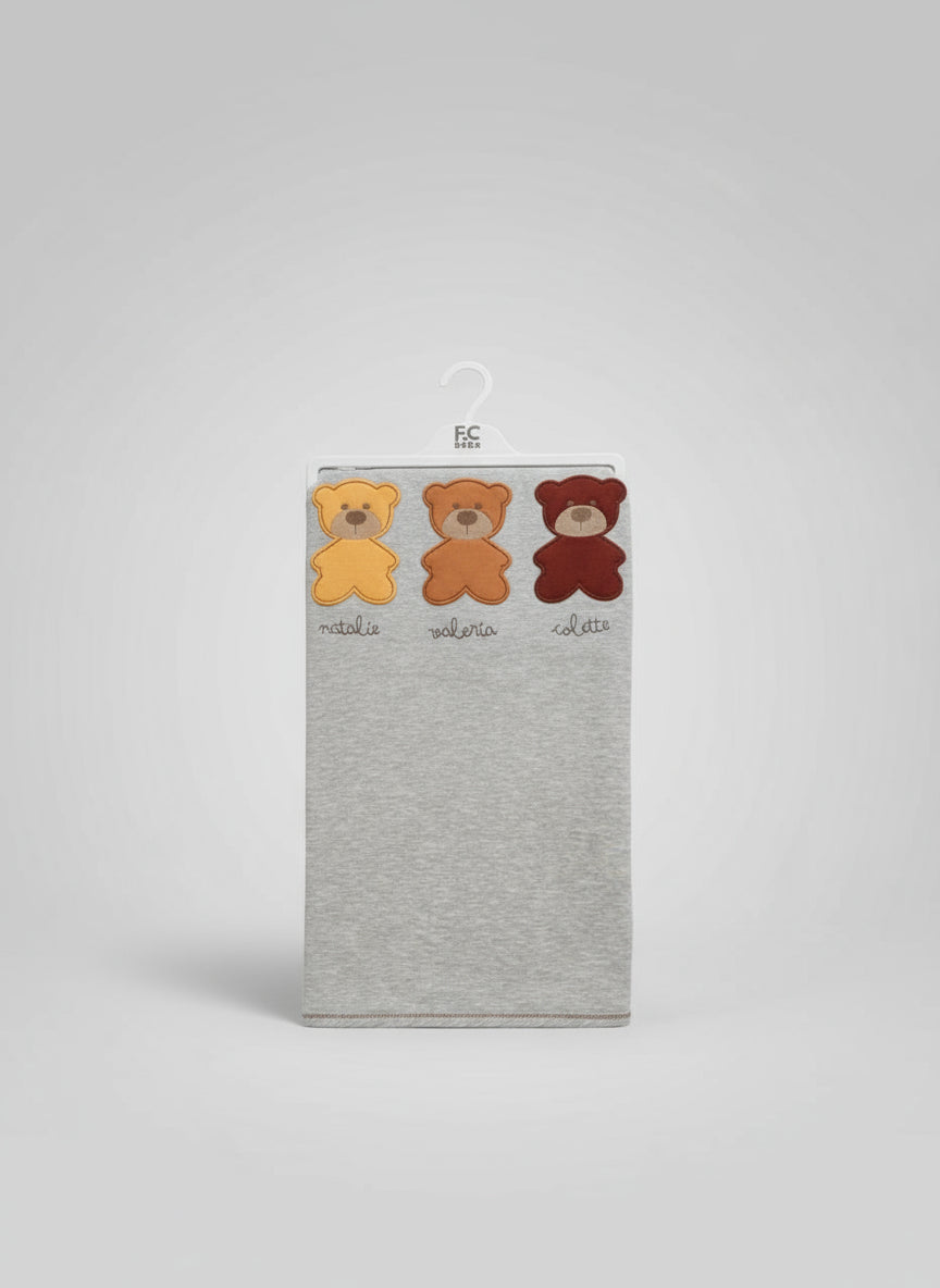 Heather grey newborn blanket on a hanger in clear packaging, mustard, orange and burgundy bear patches