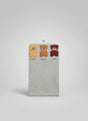 Heather grey newborn blanket on a hanger in clear packaging, mustard, orange and burgundy bear patches