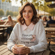 Grey teddy bear sweatshirt styled with a cream skirt outdoors