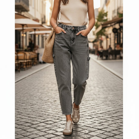 Grey wash wide leg jeans with a utility loop and front pockets worn with gold trainers