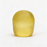 Yellow gumdrop squishy standing upright with a pebbled sugar texture