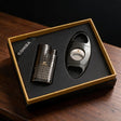 Ribbed gunmetal cigar lighter and polished oval cigar cutter in a gold edged gift box