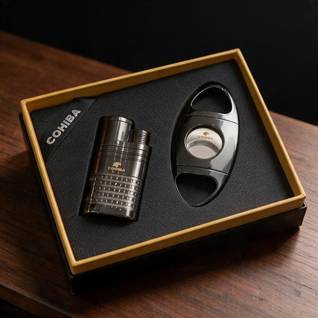 Ribbed gunmetal cigar lighter and polished oval cigar cutter in a gold edged gift box