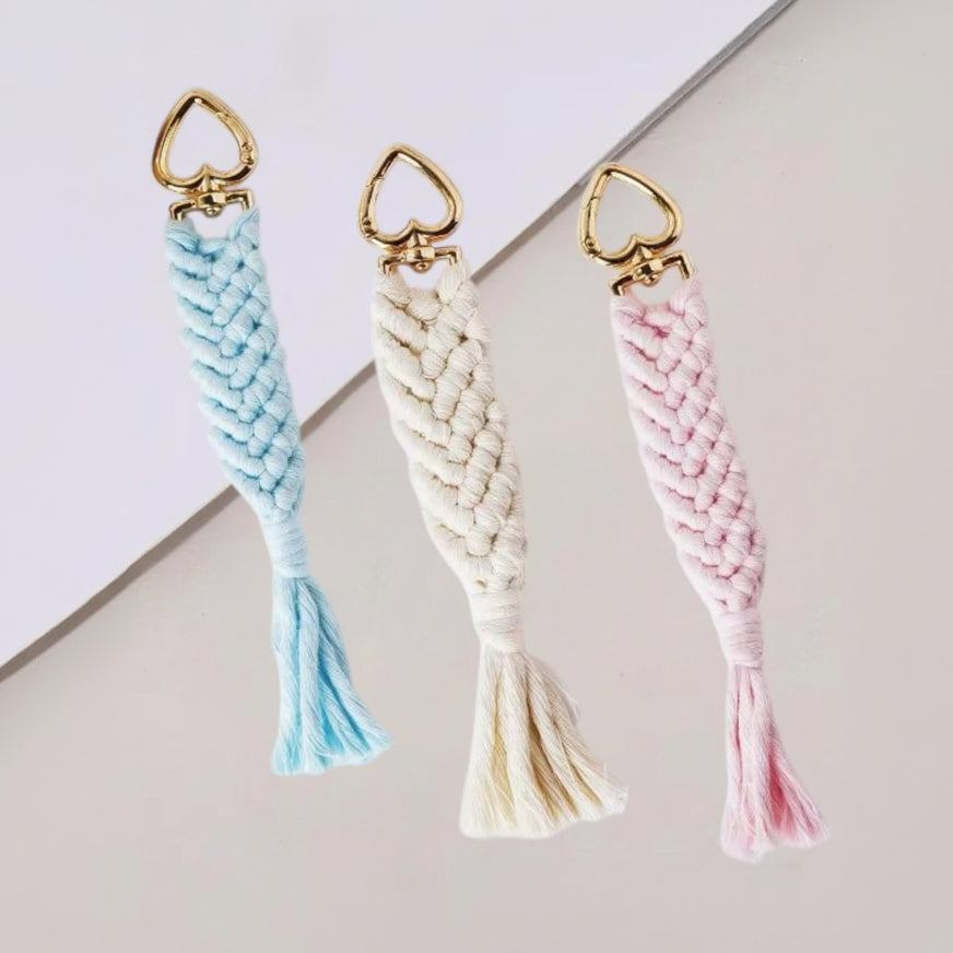 Handmade macrame keychains with gold heart clasps in blue, cream and pink