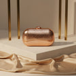 Rose gold hard case evening clutch with textured finish