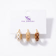 Three single harlequin enamel huggie earrings in white, beige and brown with gold lines