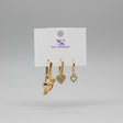 Gold heart-shaped earrings on a Jewelry card against a grey background