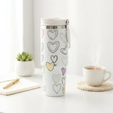 Cream travel mug with hand drawn outline hearts in pastel colours and a white lid