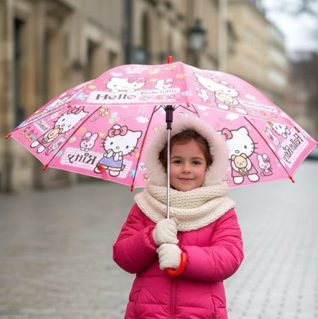 Girl in a pink coat holding an open coral pink Hello Kitty kids umbrella