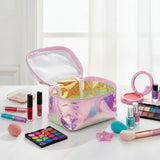 Open pink iridescent unicorn case with white lining beside eyeshadow, nail polish and brushes
