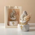 Ivory Holy Family relief beside a cream gift bag and a spray of dried pampas