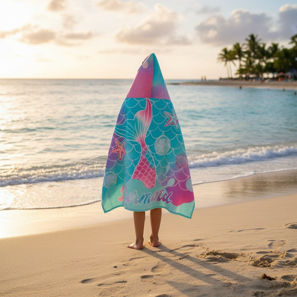Turquoise hooded towel wrap printed with a large pink mermaid tail, starfish and bubbles