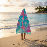 Turquoise hooded towel wrap printed with a large pink mermaid tail, starfish and bubbles