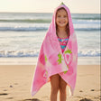 Front view of a girl in a pink strawberry hooded towel with the hood up