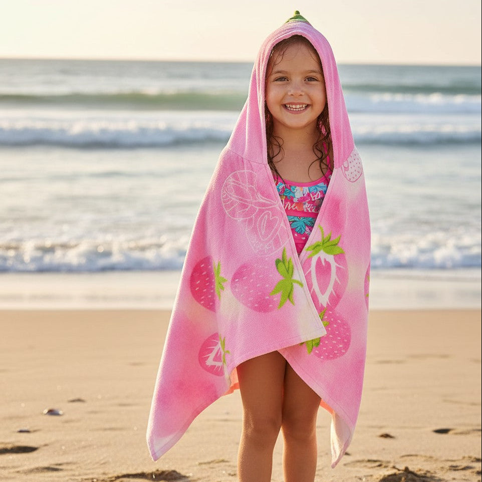 Front view of a girl in a pink strawberry hooded towel with the hood up