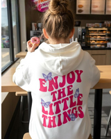 Girl in a cream oversized hoodie and hot pink joggers