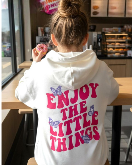 Girl in a cream oversized hoodie and hot pink joggers