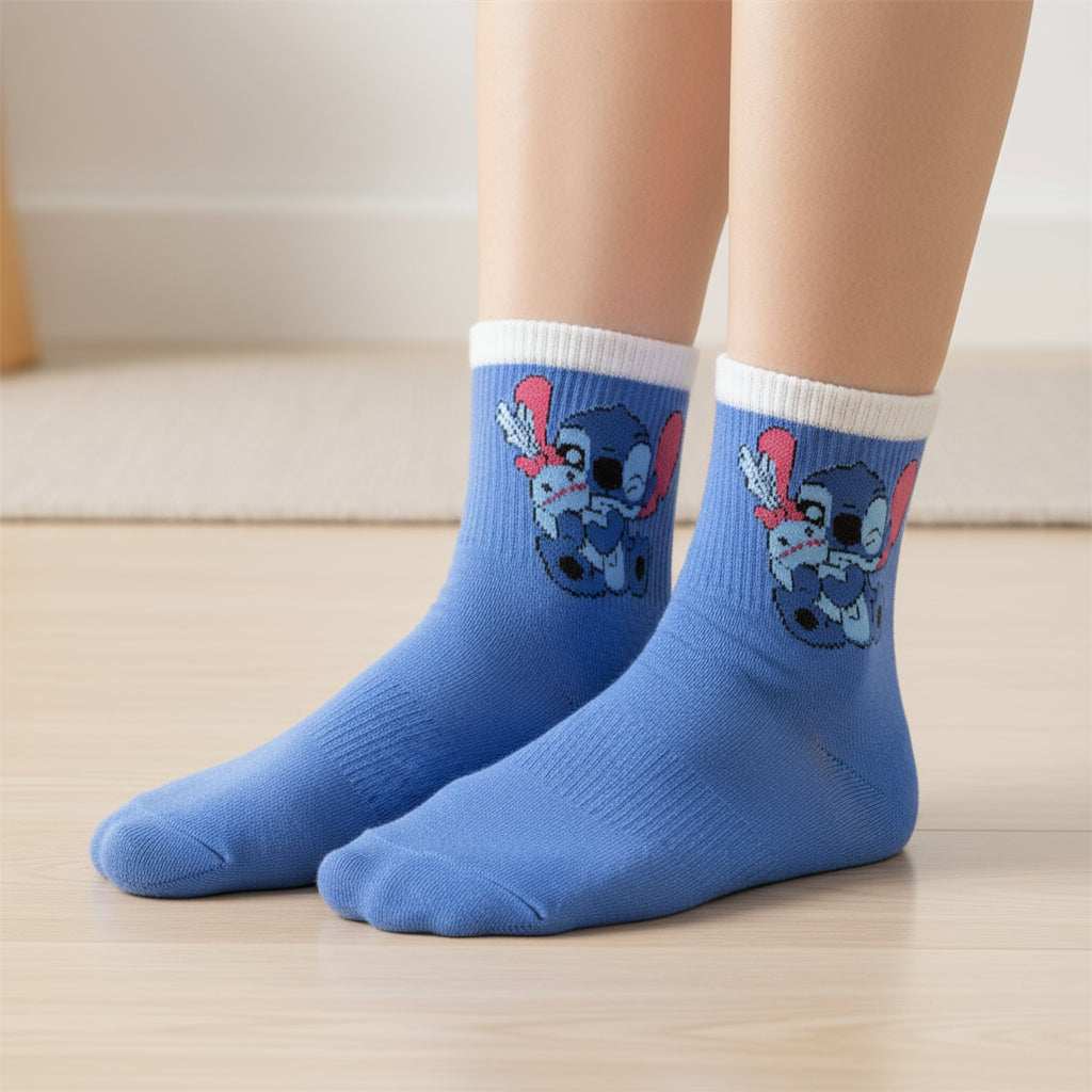 Kids cornflower blue crew socks with white cuffs and a winking Stitch print in pink, worn on feet