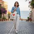 Woman carrying the I Love Batroun canvas tote on a cobbled seaside street