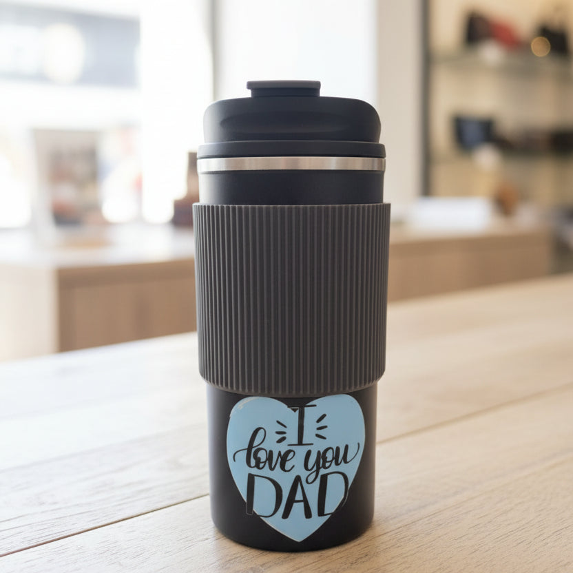 Black travel mug with 'I love you DAD' text in a store setting