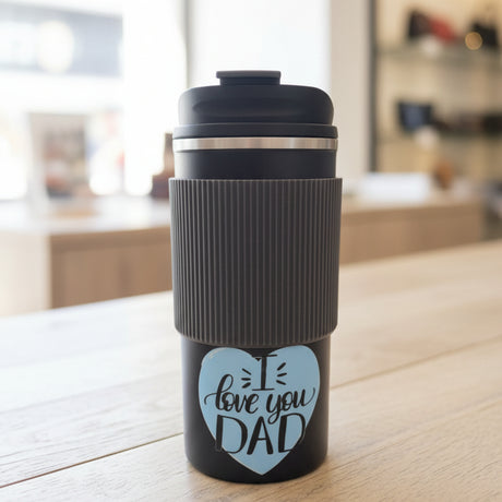 Black travel mug with 'I love you DAD' text in a store setting