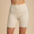 Beige athletic shorts worn by a person on a beige background