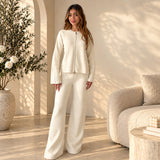 Ivory zip front knit cardigan with matching flared trousers, full length