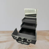 Vanity case interior showing two cantilever trays stepped out on silver scissor arms