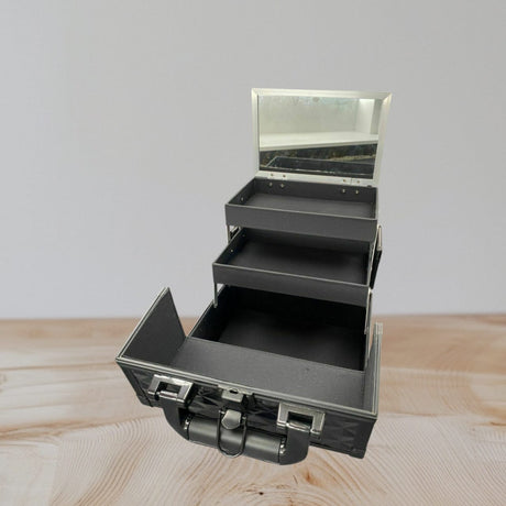 Vanity case interior showing two cantilever trays stepped out on silver scissor arms