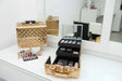 Gold studded aluminium vanity case with rose gold trim, shown closed and open on a dresser