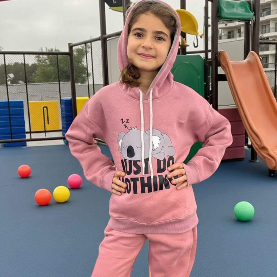 Dusty pink hooded jogging set with the hood up, worn at a playground