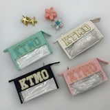 Four pouches with 'KTMO' branding on a light grey background