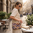 Handmade kilim bag with concentric diamond weave in blue, mustard and berry on a gold chain